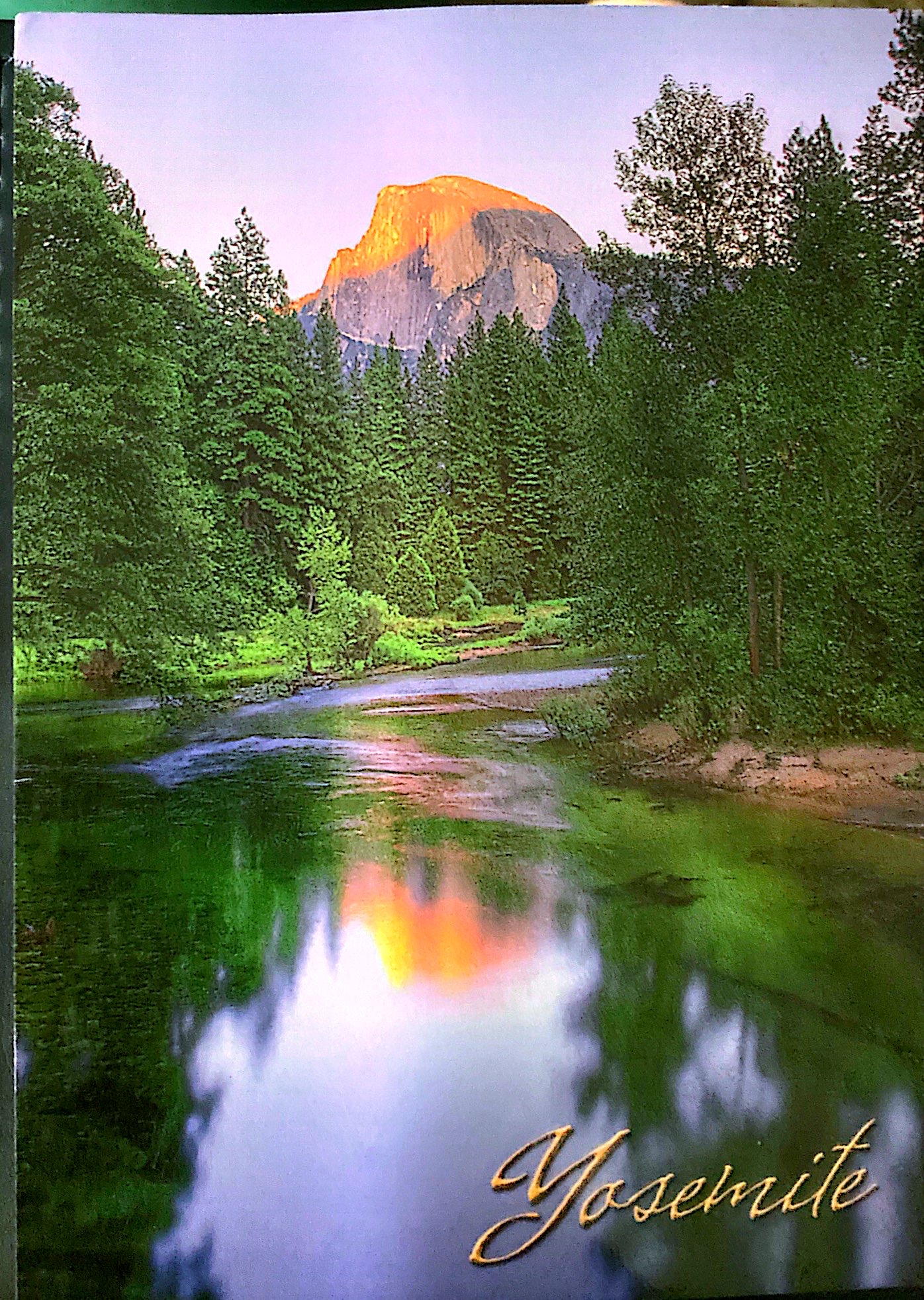 A river and large mountain behind it in Yosemite, but sunset
